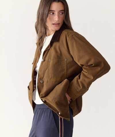 Model wearing the brown Riley Barn Jacket with a corduroy collar, side view, against a white background.