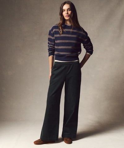 Model wearing dark green Allison Corduroy Trouser, a wide-leg style, paired with a striped sweater.