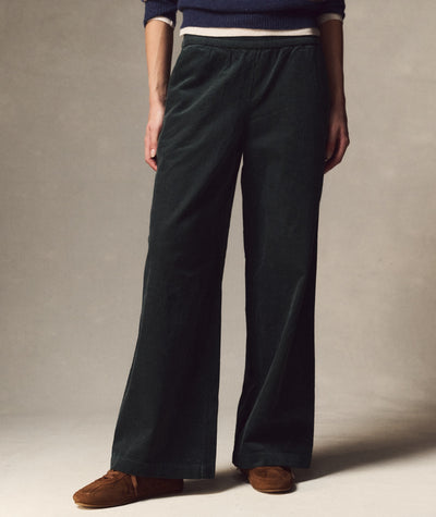 Model wearing dark green Allison Corduroy Trouser with elastic waist and wide-leg fit, front view.