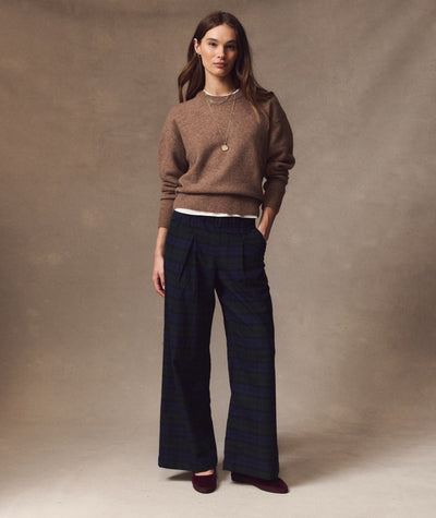 Model wears navy and green striped Allison Pleated Moleskin Trouser with a brown sweater.