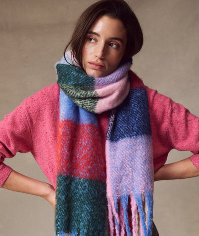 Model wearing a colorful plaid Brushed Scarf in pink, blue, and green, styled with a pink sweater.