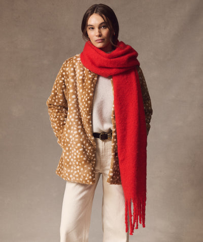 Model wearing a bright red Brushed Scarf with a fawn-print coat and cream sweater.