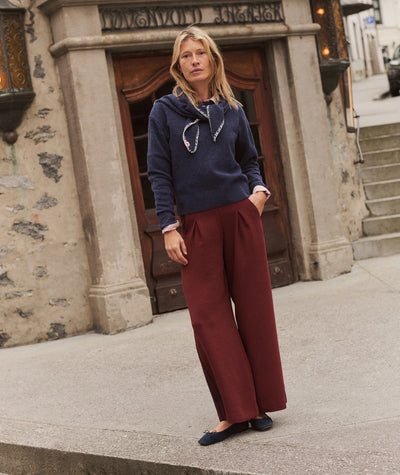 Model wearing burgundy Allison Pleated Wide Leg Trouser with a navy sweater and flats.