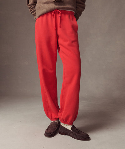 Model wearing bright red Cloud 9 Fleece Sweatpant with brown loafers, front view.