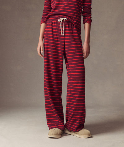 Model wears Double Knit Wide Leg Pant in red and burgundy stripes with a drawstring waist, front view.