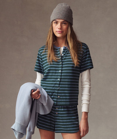 Model wearing a green and blue striped Double Knit Top over a white long-sleeve tee with matching shorts.