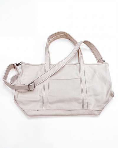 Day Trip Canvas Tote in natural off-white canvas with shoulder strap and exterior pocket, front view.